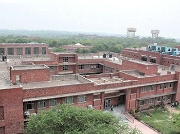 An image of the red brick building of Jawaharlal Nehru University, established in 1969