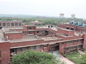 An image of the red brick building of Jawaharlal Nehru University, established in 1969