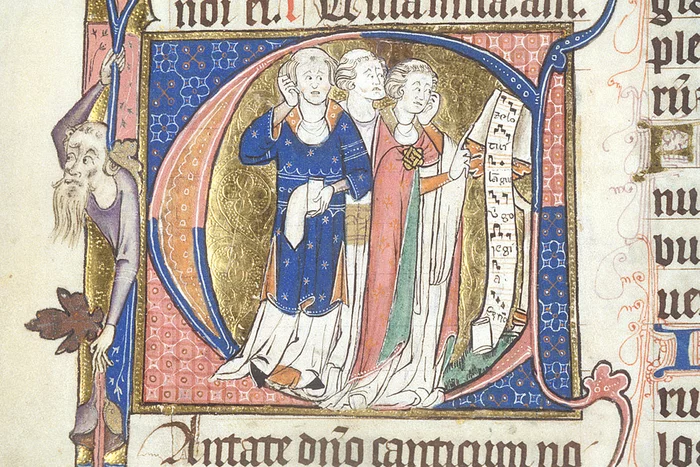 Manuscript initial of the letter C. Within the letter can be seen three clerics with tonsures, singing the motet Zelo tui langueo from a scroll of music at a lectern. The chief colours of the illumination are red and blue, with gold and green also featuring in the robes and the background.