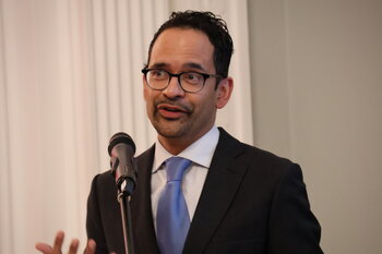 Picture of Sunil Amrith speaking into a microphone.