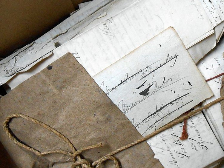 A bundle of manuscript documents and letters, tied up in brown paper and string, from the Prize Papers collection of the High Court of Admiralty, now at the National Archives, Kew