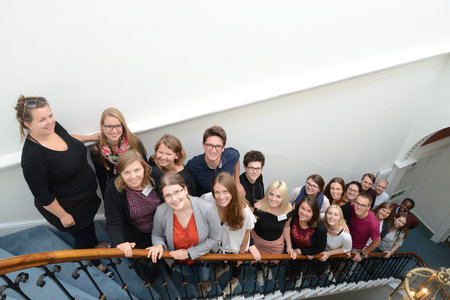 A group of summer school participants gathered on the main staircase at the GHIL