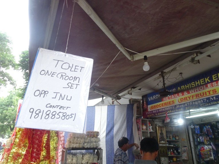 An advertisement for rooms to let hanging outside a shop in Munirka, Delhi