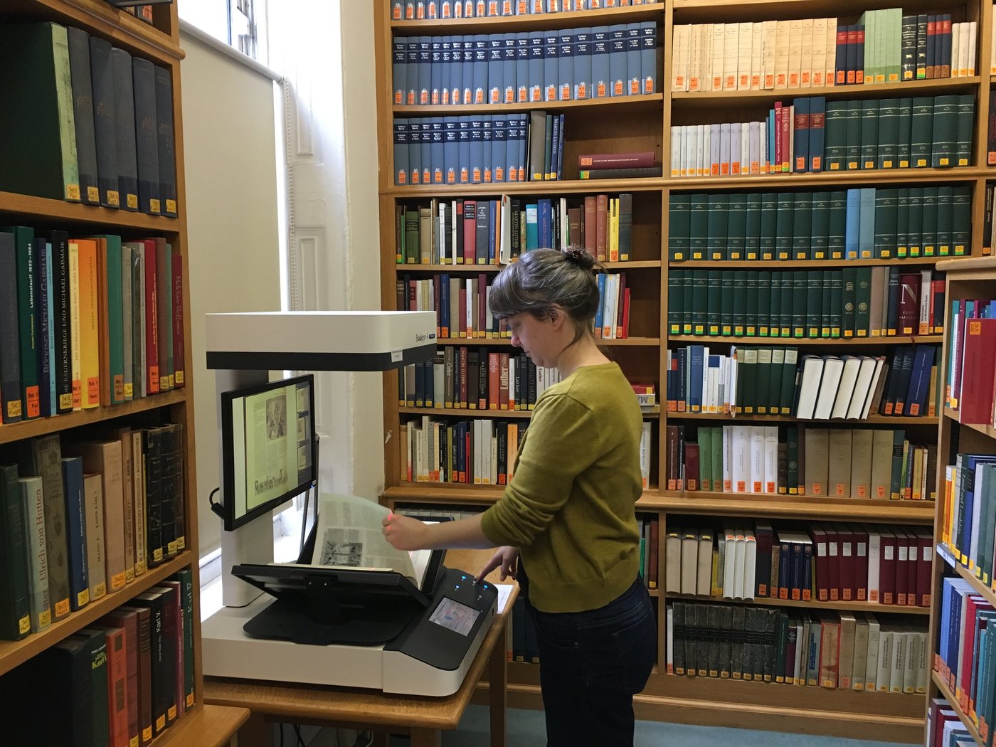 Using the ground-floor book scanner A reader using the ground-floor book scanner