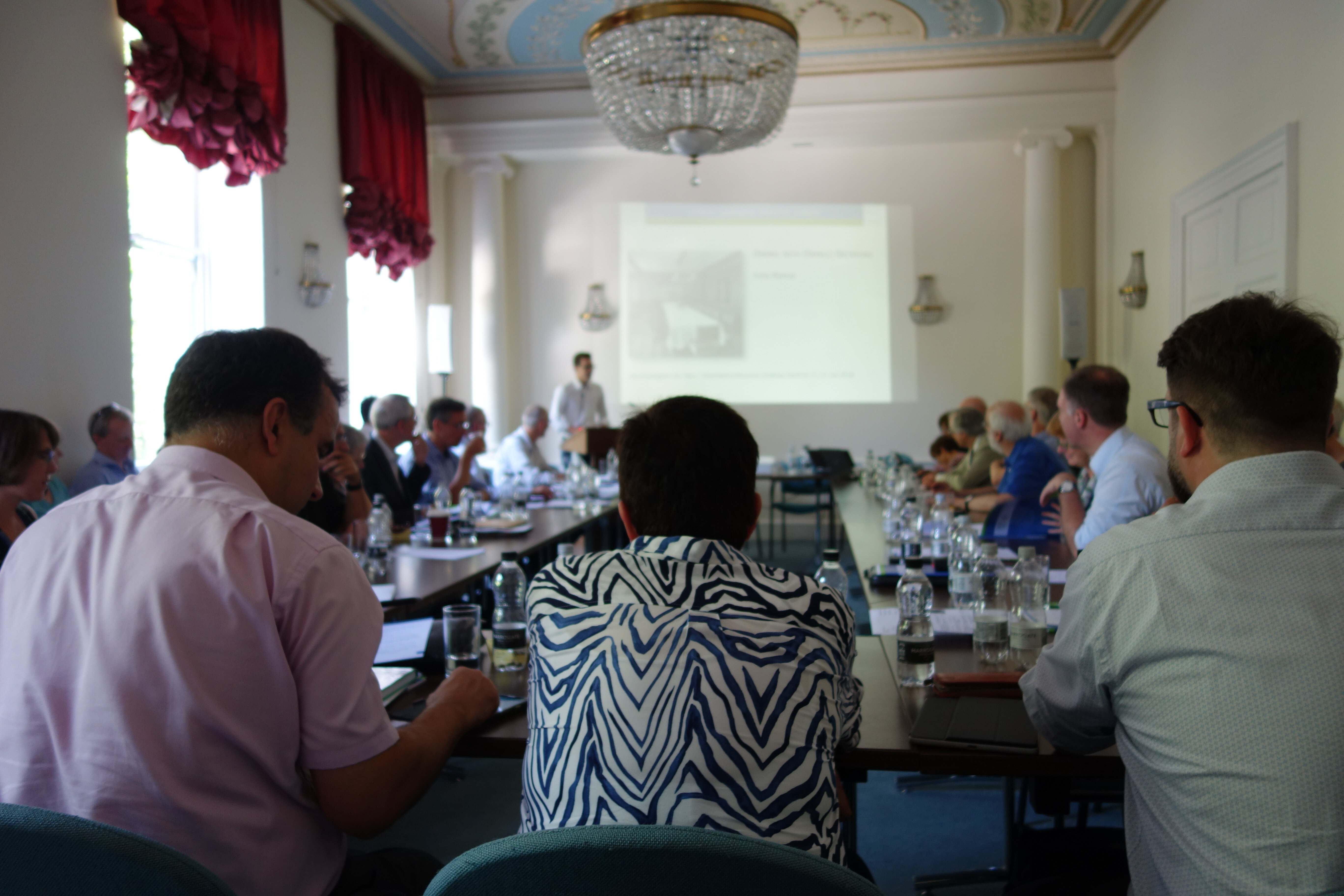 Seminar attendees seated around the tables set out in the Seminar Room at the GHIL.