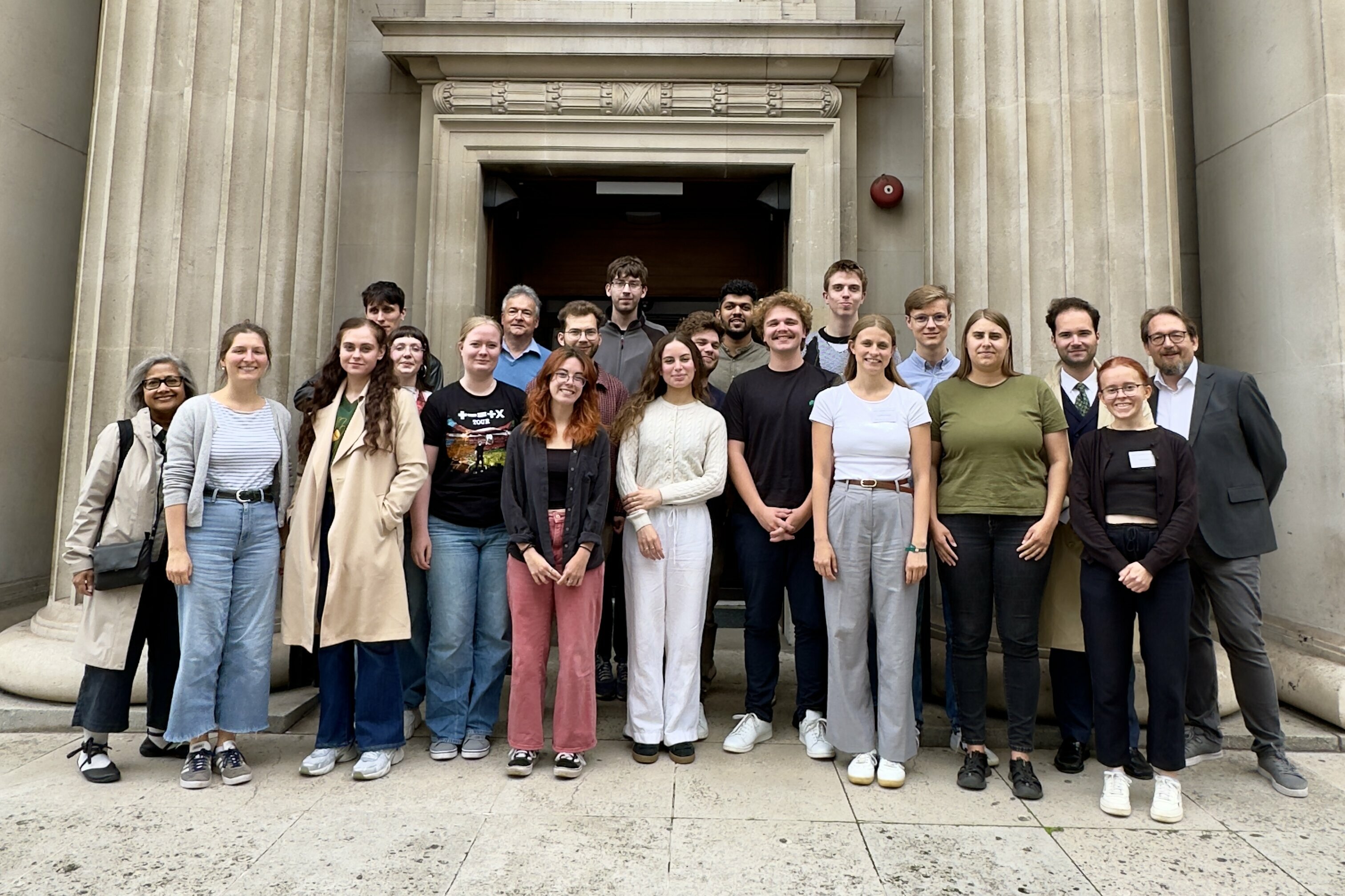 Group photograph of students and course leaders of the 2025 Summer School, taken outside Drayton House, where it took place