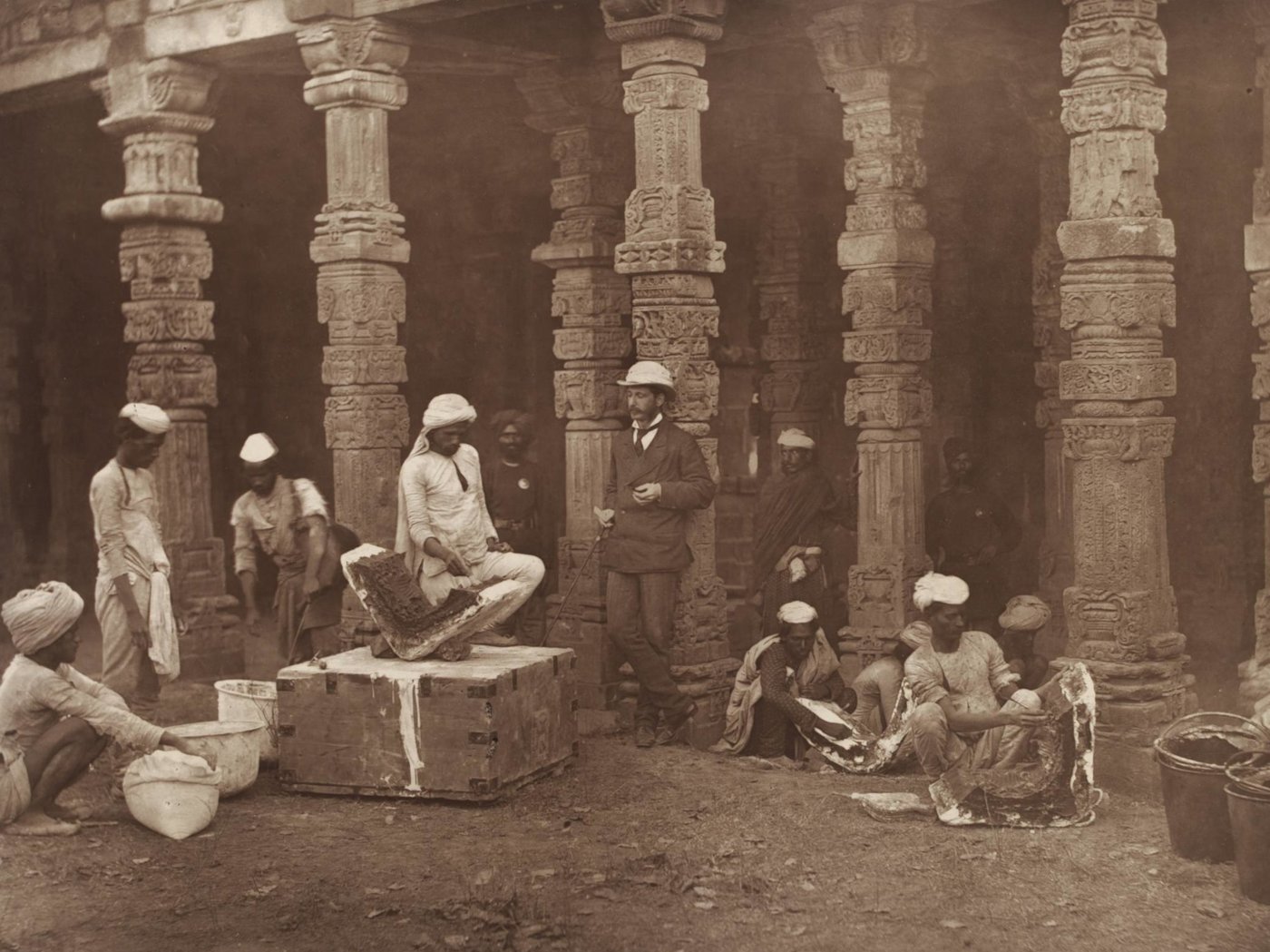 Indian moulders, supervised by a colonial official, at work. Qutb Minar, Delhi, 1856