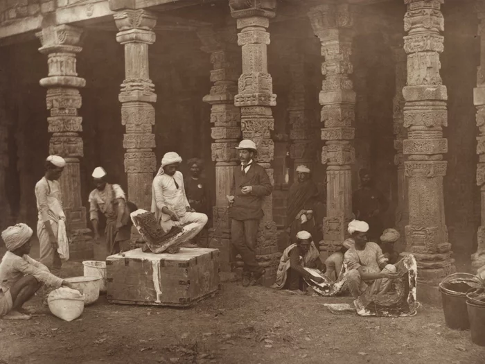 Indian moulders, supervised by a colonial official, at work. Qutb Minar, Delhi, 1856.