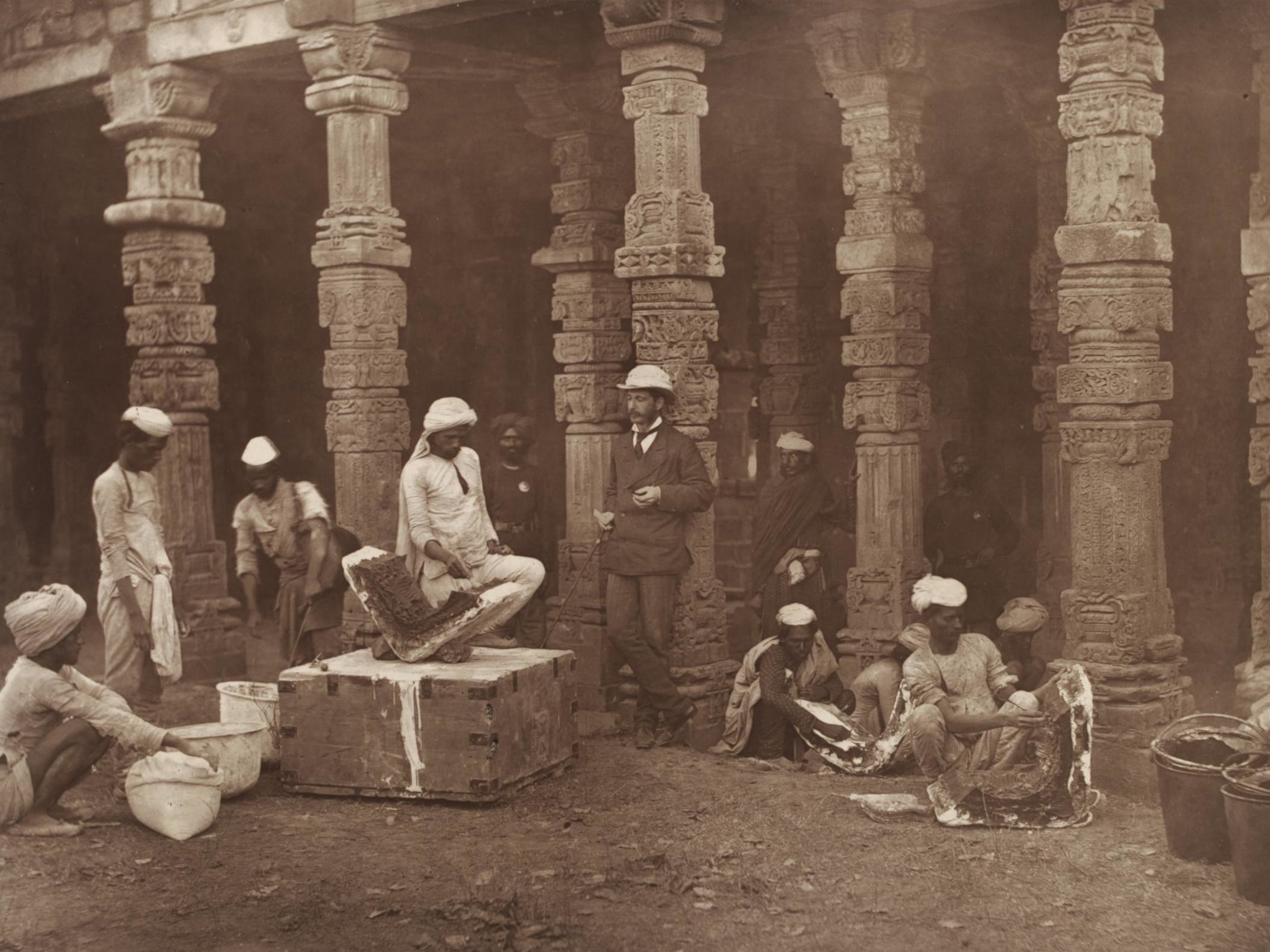 Indian moulders, Delhi, 1856 Indian moulders, supervised by a colonial official, at work. Qutb Minar, Delhi, 1856