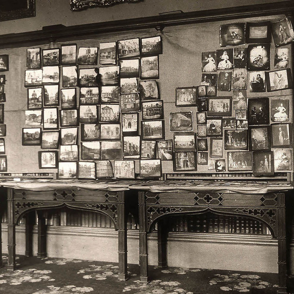 Centenary photography exhibition, Lacock Abbey, 1934 Image of a room of the centenary photography exhibition, held at Lacock Abbey, 1934, which depicts several tables and wall covered with a selection of Fox Talbot's photographs