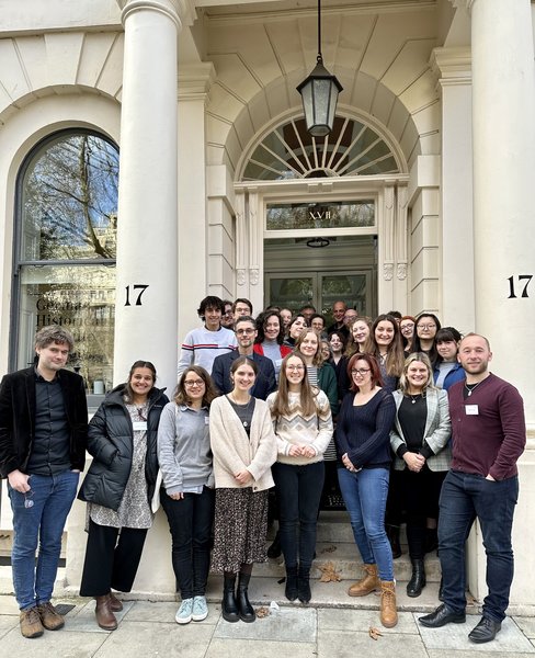 Group of postgraduate students gathered around the entrance to the GHIL