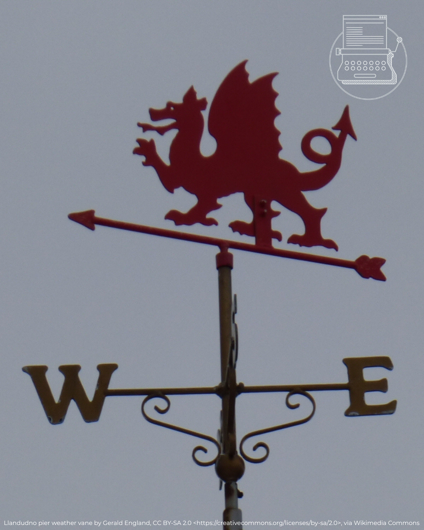 Photo of a Welsh weather vane with a red dragon on top and the grey sky in the background.