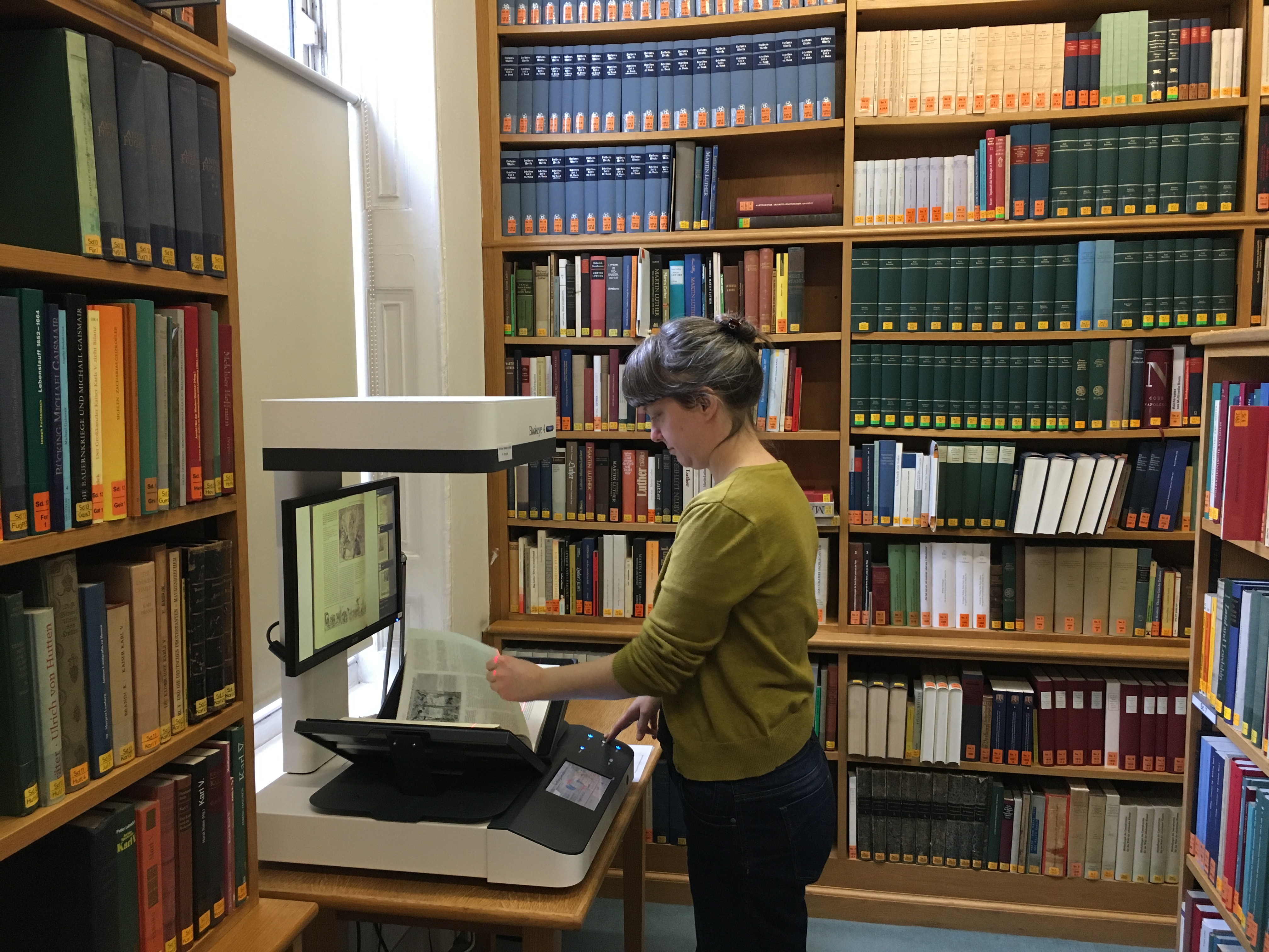 Using the ground-floor book scanner A reader using the ground-floor book scanner